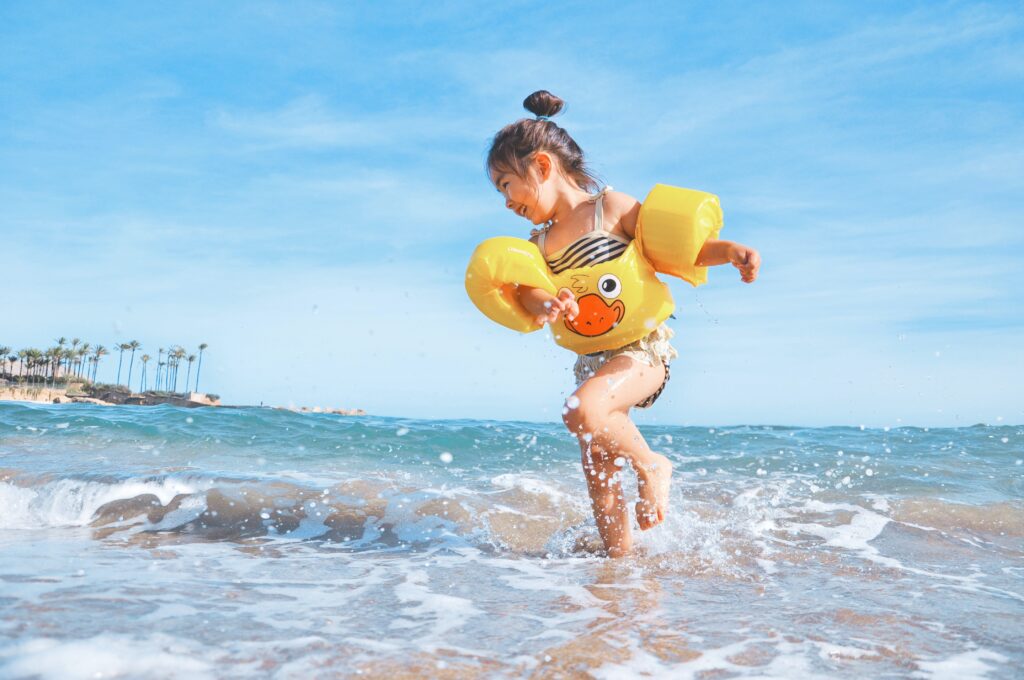 kid playing in the ocean in florida