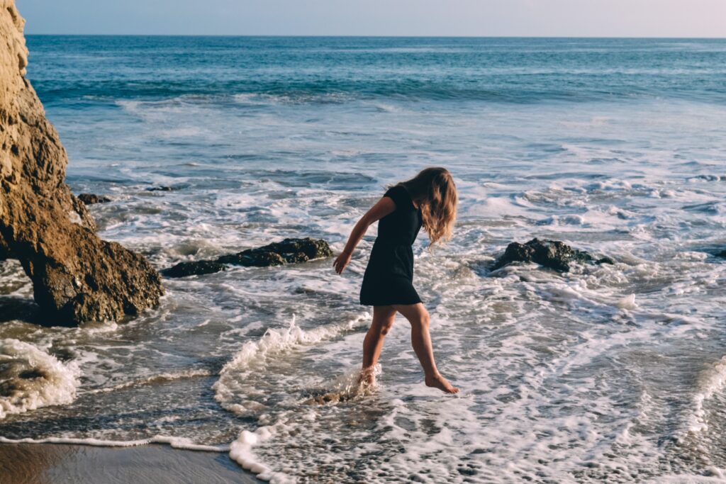 girl walking in the water at El Matador State Beach